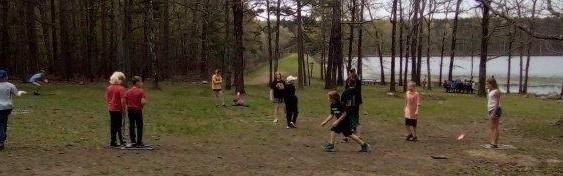 Students and presenter playing the quail habitat game at the Eco Day at the Piney Wood Rec Area